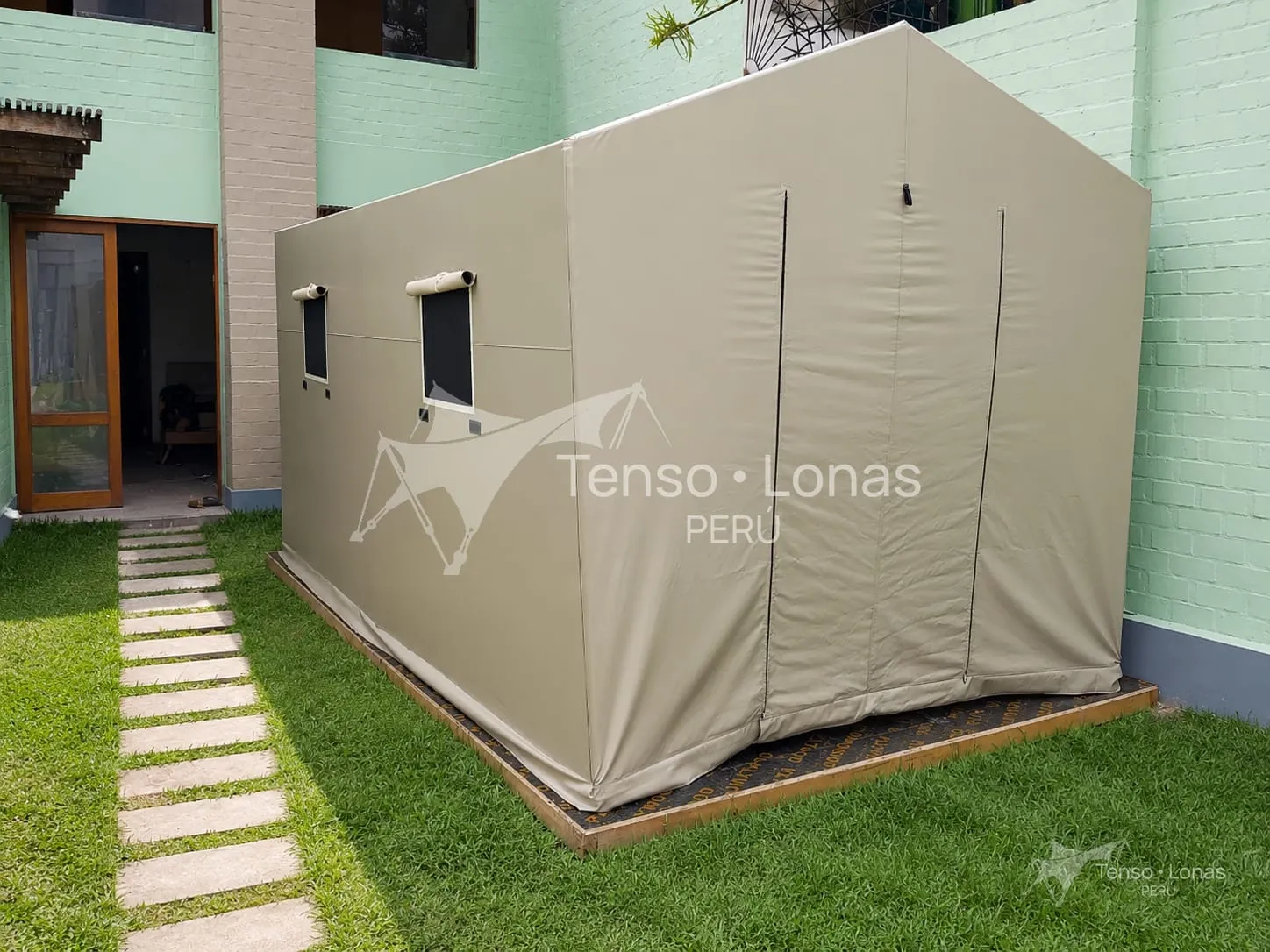 Carpa cerrada modelo dos aguas instalada sobre césped