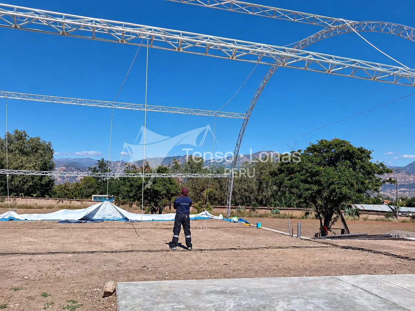 Técnico supervisando el montaje de la estructura metálica de una cobertura antes de tensar la lona